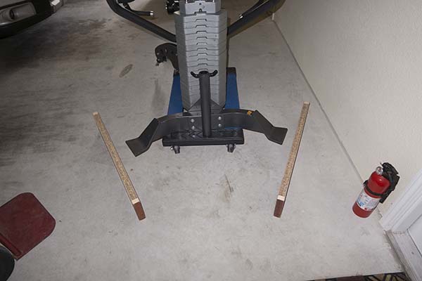 Photograph of Hoist V5 home gym with plate end base about to be raised onto wooden blocks during post-assembly process.